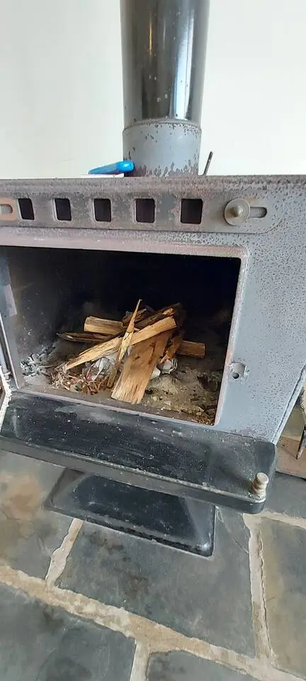 The wood fireplace at The Deck, Crescent Head — a cosy spot on a rainy day