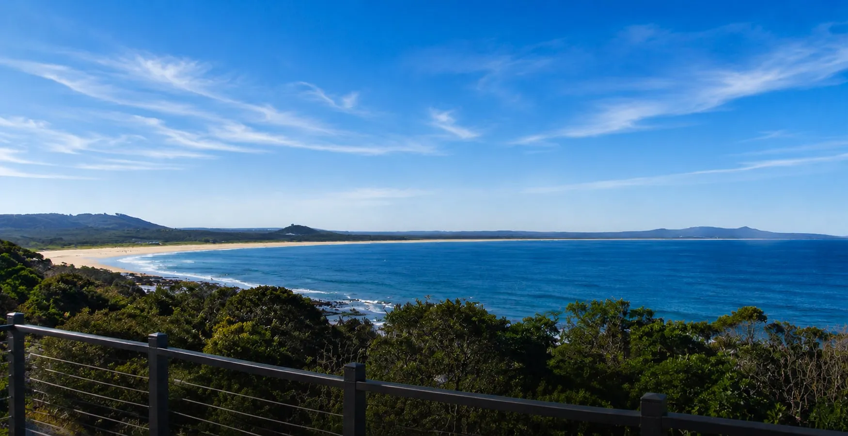 The view from the deck at The Deck, Crescent Head NSW — looking south over the bay to Hat Head